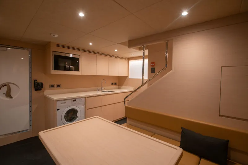 Slide: The Image of Luxurious interior of 2025 Nomad 95 SUV yacht with modern kitchen and seating area. - 13