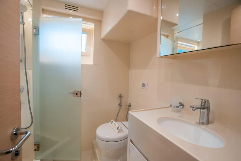Slide: The Image of Modern bathroom interior in Nomad 95 SUV, 2025 model, featuring sleek fixtures and frosted glass shower. - 15
