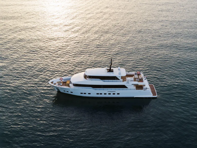 Slide: The Image of Luxury Nomad 95 SUV yacht cruising on calm ocean waters, 2025 model. - 36