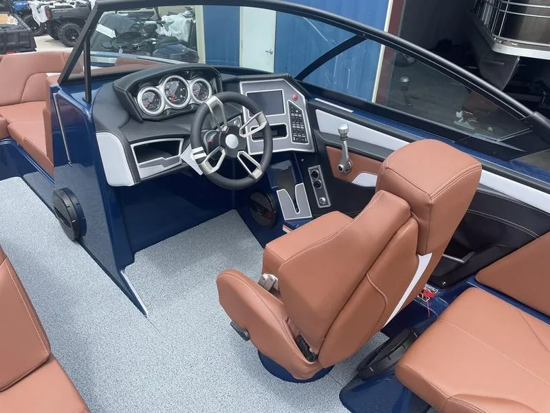 Slide: The Image of 2023 MasterCraft XT24 boat interior with brown seats and modern dashboard. - 12