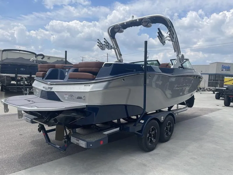 Slide: The Image of 2023 MasterCraft XT24 boat on a trailer, ready for transport. - 5