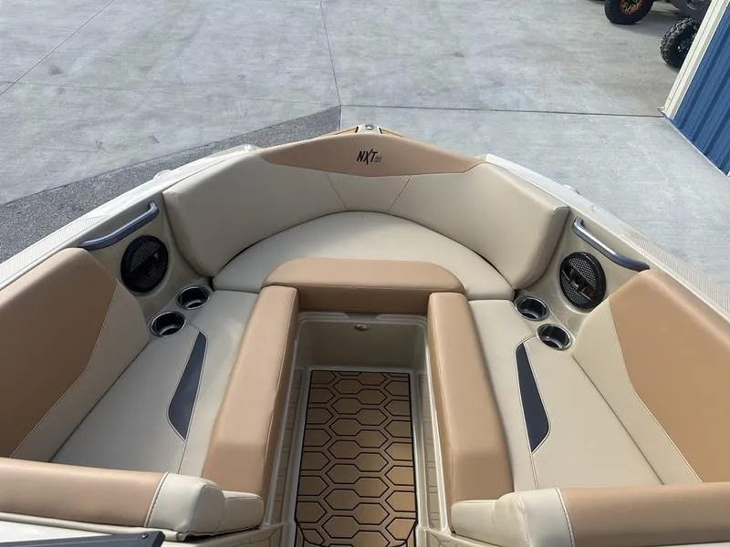 Slide: The Image of 2024 MasterCraft NXT21 boat interior with beige and tan seating. - 12