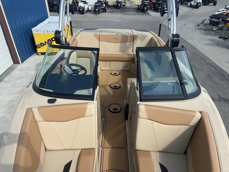 Slide: The Image of 2024 MasterCraft NXT21 boat interior with tan seats and open windshield. - 16