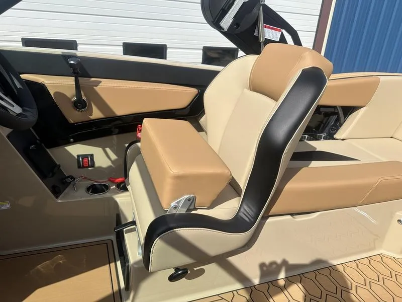 Slide: The Image of 2024 MasterCraft NXT21 boat interior with tan and black seating. - 8