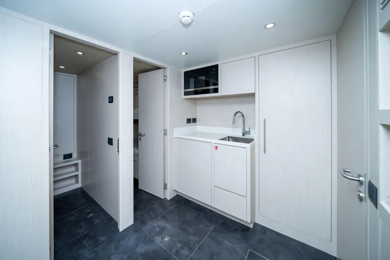 Slide: The Image of Modern interior of 2025 Nomad 75 SUV with sleek kitchenette and storage. - 17