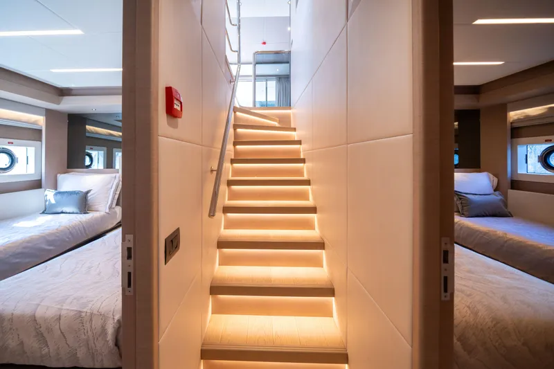 Slide: The Image of Luxurious interior of 2025 Nomad 75 SUV yacht with illuminated staircase and cozy bedrooms. - 21