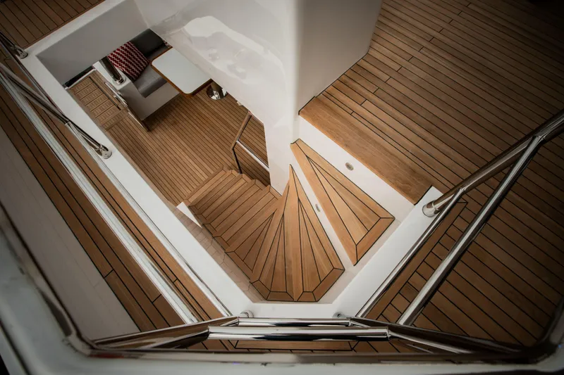 Slide: The Image of Staircase on Nomad 75 SUV yacht, featuring sleek wooden design and modern railings, 2025 model. - 22