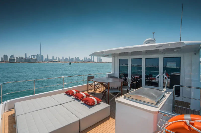 Slide: The Image of Luxurious Nomad 75 SUV yacht deck with Dubai skyline view, 2025 model. - 23