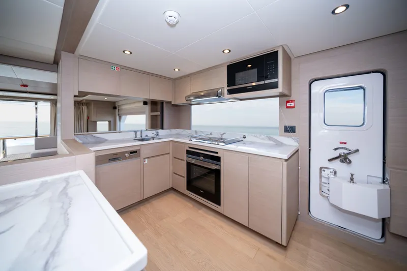 Slide: The Image of Modern kitchen interior in 2025 Nomad 75 SUV yacht, featuring sleek appliances and ocean view. - 7