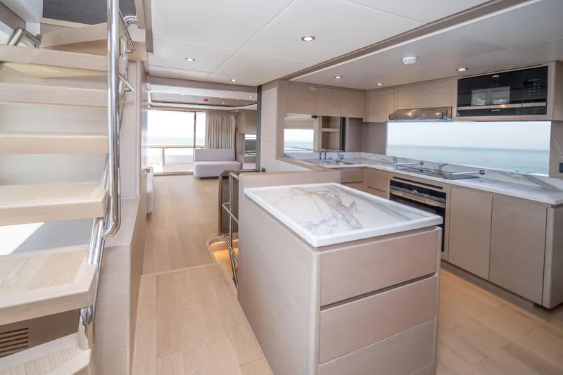 Slide: The Image of Luxurious interior of 2025 Nomad 75 SUV yacht with modern kitchen and ocean view. - 8