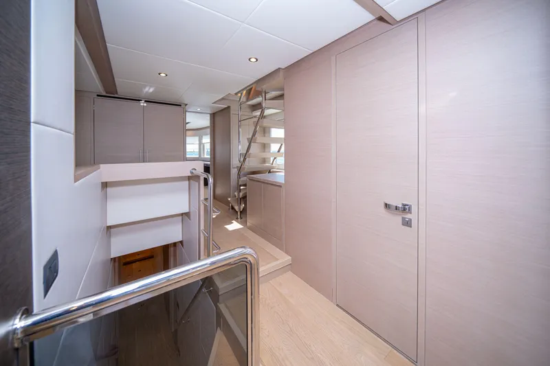 Slide: The Image of Interior of 2025 Nomad 75 SUV yacht, featuring modern design and sleek staircase. - 19