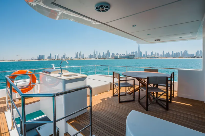 Slide: The Image of Luxurious Nomad 75 SUV yacht deck with city skyline view, 2025 model. - 24