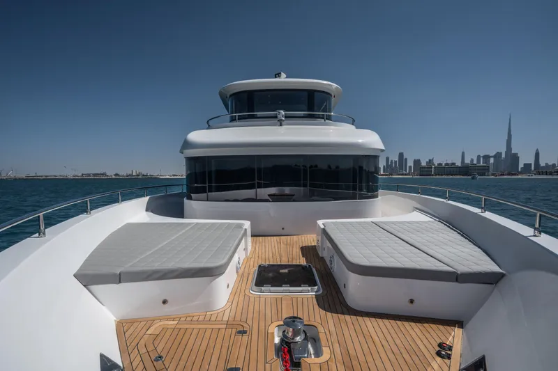 Slide: The Image of Luxurious Nomad 75 SUV yacht deck with city skyline in the background, 2025 model. - 28