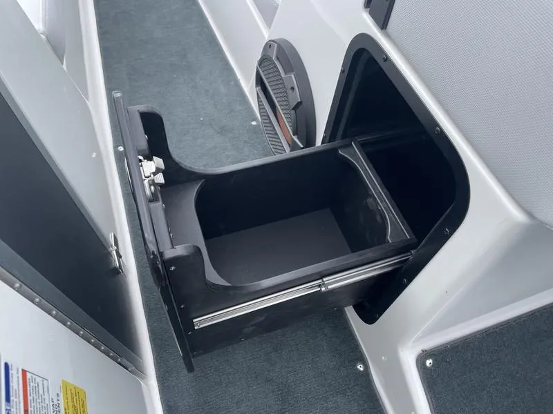 Slide: The Image of 2019 MasterCraft X26 boat storage compartment with pull-out drawer. - 10