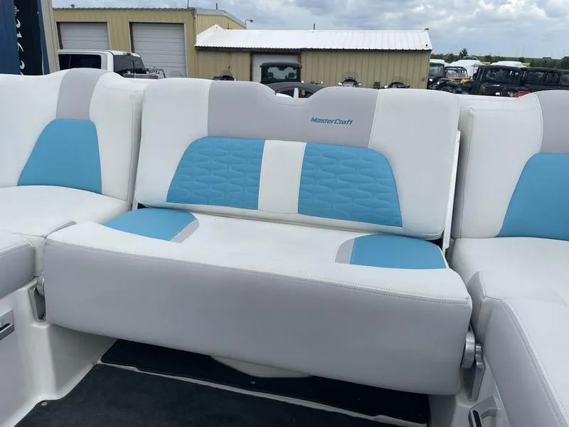Slide: The Image of 2019 MasterCraft X26 boat interior with white and blue seating. - 12