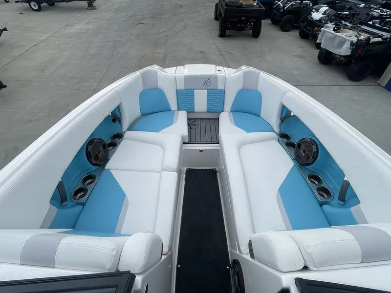 Slide: The Image of 2019 MasterCraft X26 boat interior with white and blue seating. - 13
