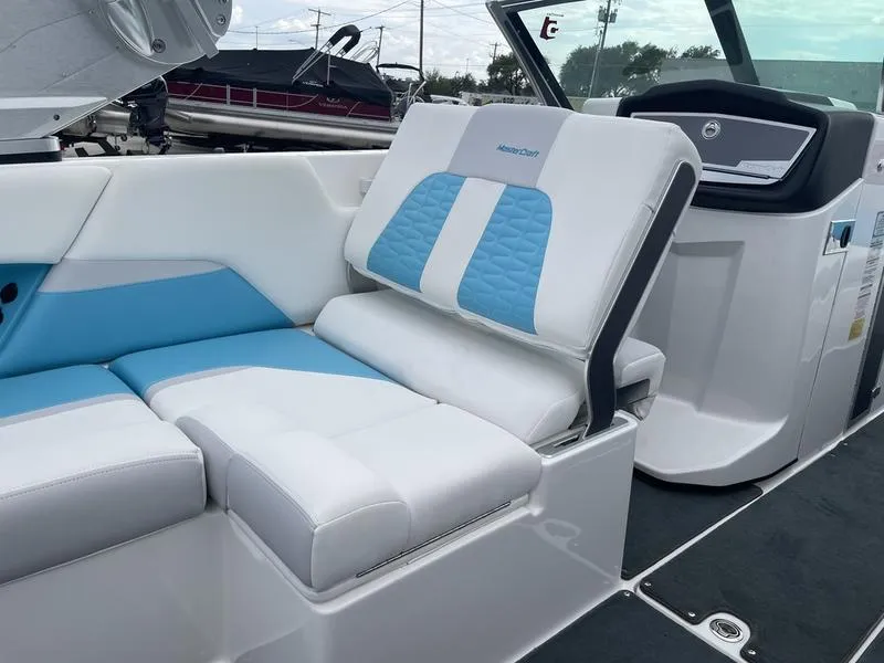 Slide: The Image of 2019 MasterCraft X26 boat interior with white and blue seating. - 16