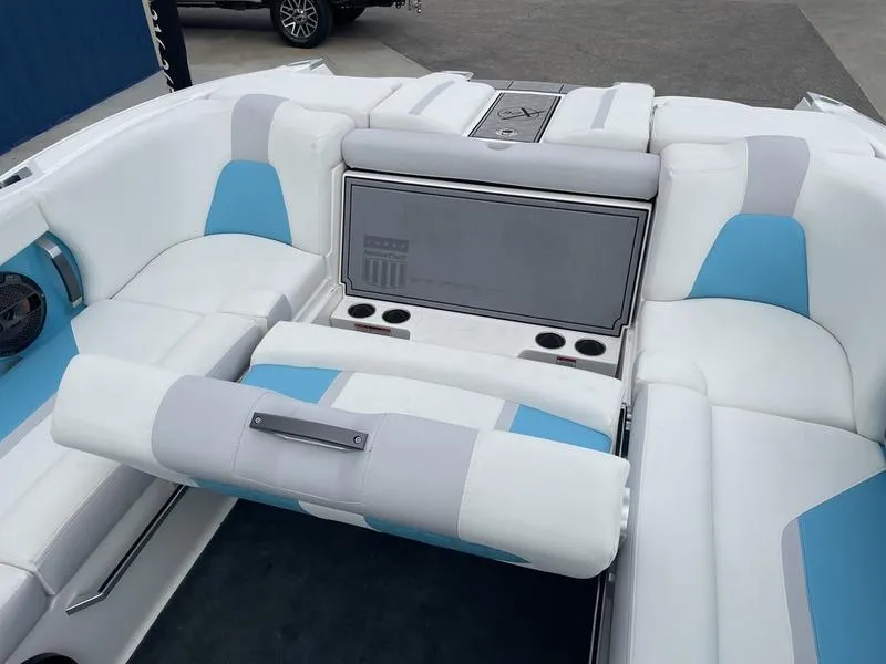 Slide: The Image of 2019 MasterCraft X26 boat interior with white and blue seating. - 17