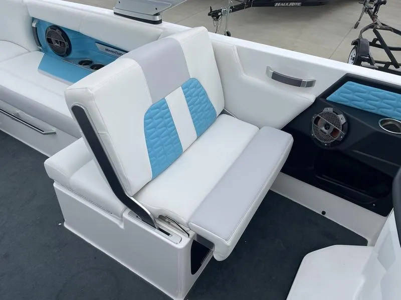 Slide: The Image of 2019 MasterCraft X26 boat interior with white and blue seating. - 18