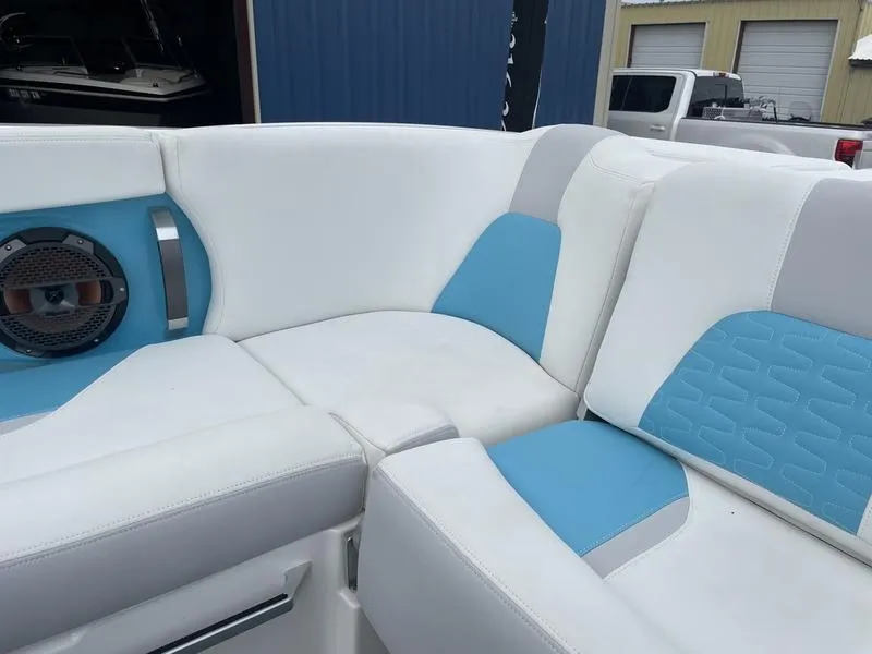 Slide: The Image of 2019 MasterCraft X26 boat interior with white and blue seating. - 19