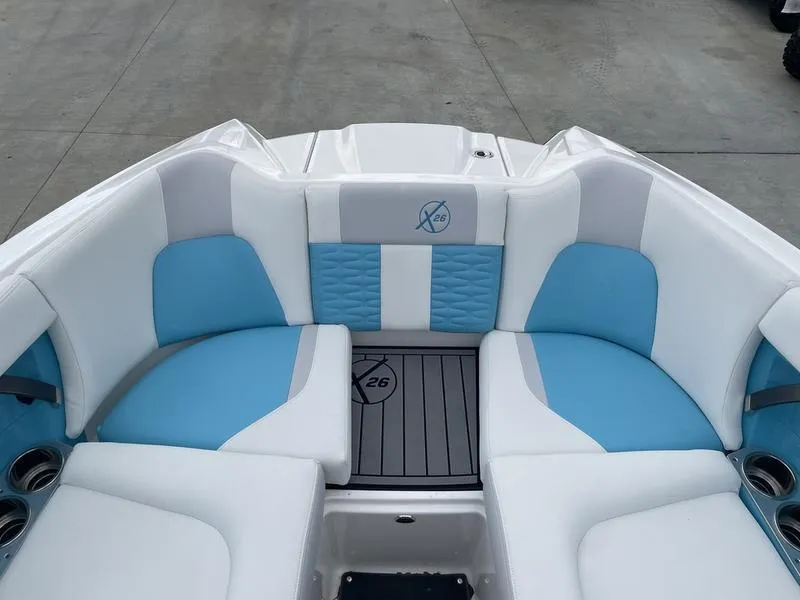 Slide: The Image of 2019 MasterCraft X26 boat interior with blue and white seating. - 22