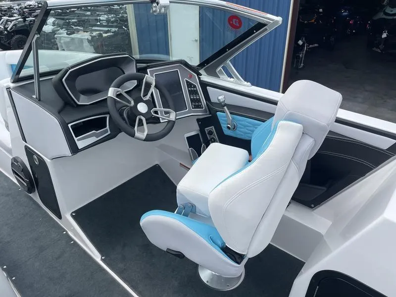 Slide: The Image of 2019 MasterCraft X26 boat cockpit with modern steering wheel and captain's chair. - 24