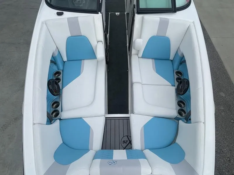 Slide: The Image of 2019 MasterCraft X26 boat interior with blue and white seating. - 26