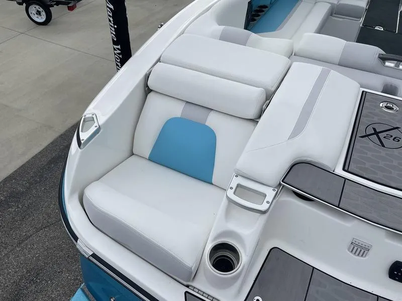 Slide: The Image of 2019 MasterCraft X26 boat interior with white and blue seating. - 8