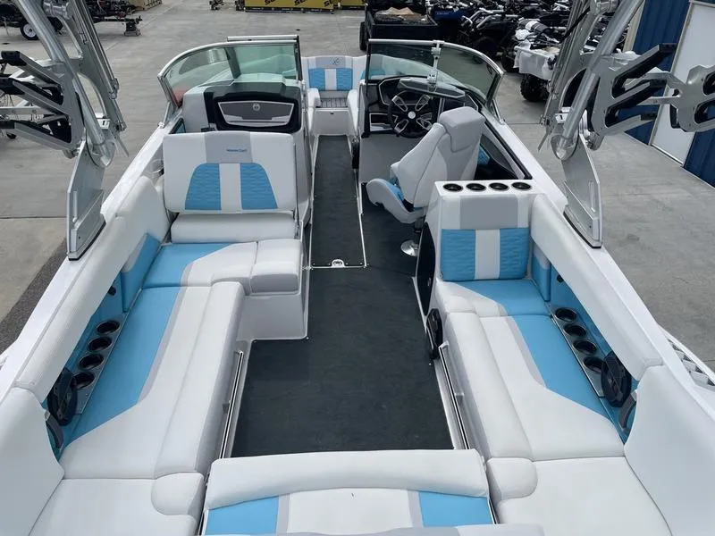 Slide: The Image of 2019 MasterCraft X26 boat interior with white and blue seating. - 9