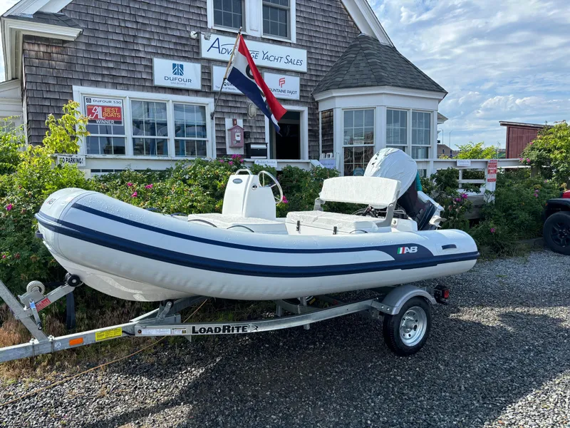 Slide: The Image of 2024 AB Inflatables Mares 12 VSX boat on Load Rite trailer outside yacht sales office. - 2