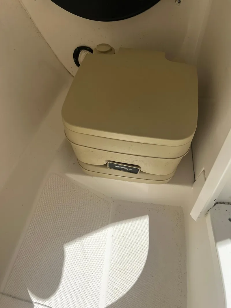 Slide: The Image of Portable toilet in 2014 Rinker 246 Captiva Bowrider boat. - 16