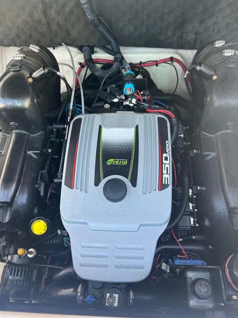 Slide: The Image of 2014 Rinker 246 Captiva Bowrider engine compartment with 350 MAG motor. - 18