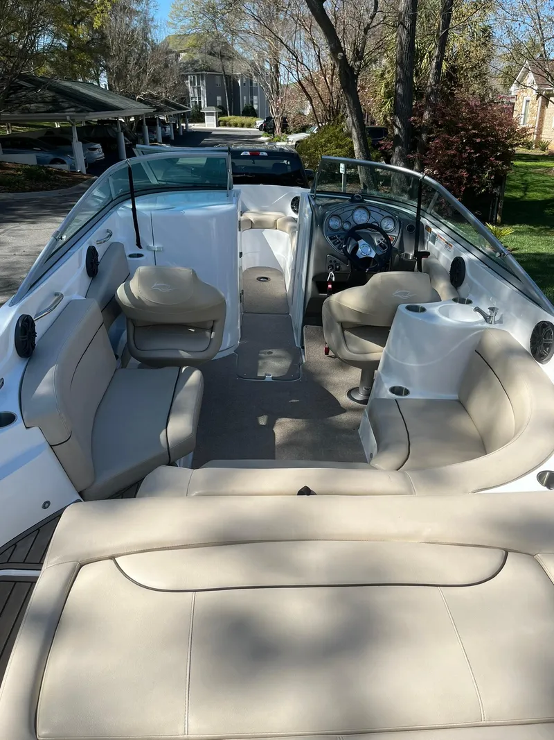 Slide: The Image of 2014 Rinker 246 Captiva Bowrider with beige seating and spacious interior. - 23