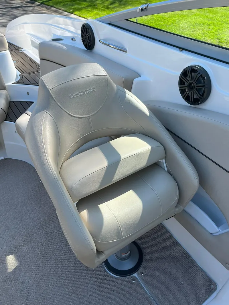 Slide: The Image of 2014 Rinker 246 Captiva Bowrider captain's chair with beige upholstery. - 4