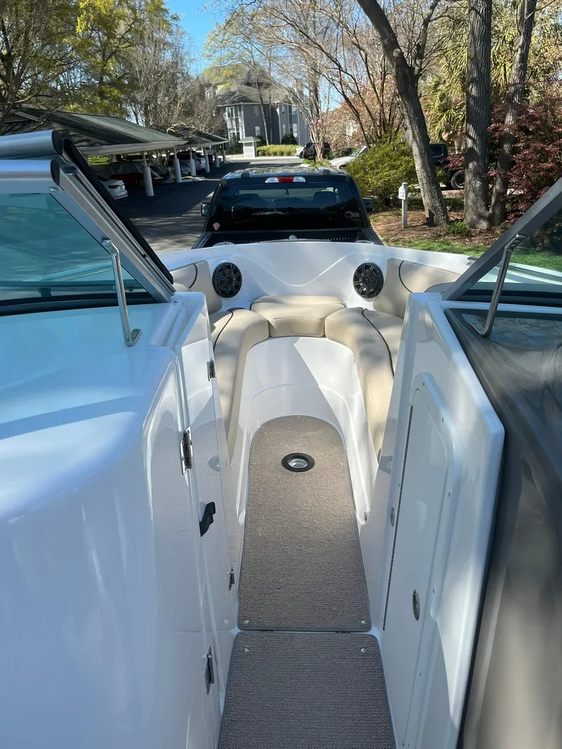 Slide: The Image of 2014 Rinker 246 Captiva Bowrider interior view with seating and dashboard. - 6