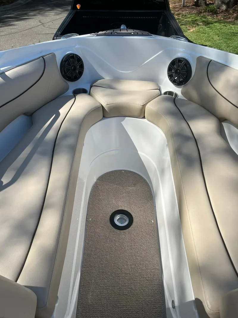 Slide: The Image of 2014 Rinker 246 Captiva Bowrider interior with beige seating and speakers. - 7