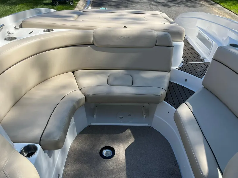 Slide: The Image of 2014 Rinker 246 Captiva Bowrider interior with beige seating and cup holders. - 9