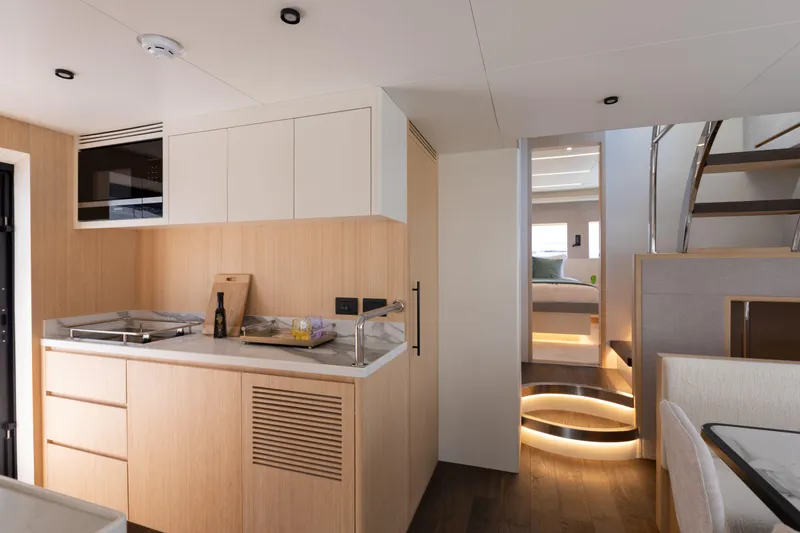 Slide: The Image of Modern kitchen interior of 2025 Nomad 70 SUV yacht with sleek design and wooden accents. - 10