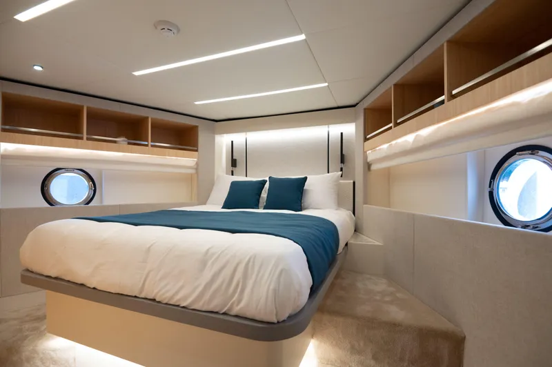 Slide: The Image of Luxurious bedroom interior of 2025 Nomad 70 SUV yacht with modern design and porthole windows. - 12