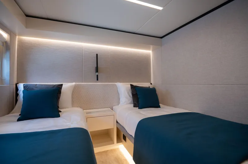 Slide: The Image of Luxurious twin bedroom in 2025 Nomad 70 SUV yacht, featuring modern design and ambient lighting. - 15