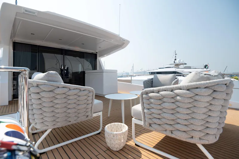 Slide: The Image of Luxury deck of 2025 Nomad 70 SUV yacht with stylish seating and table. - 21