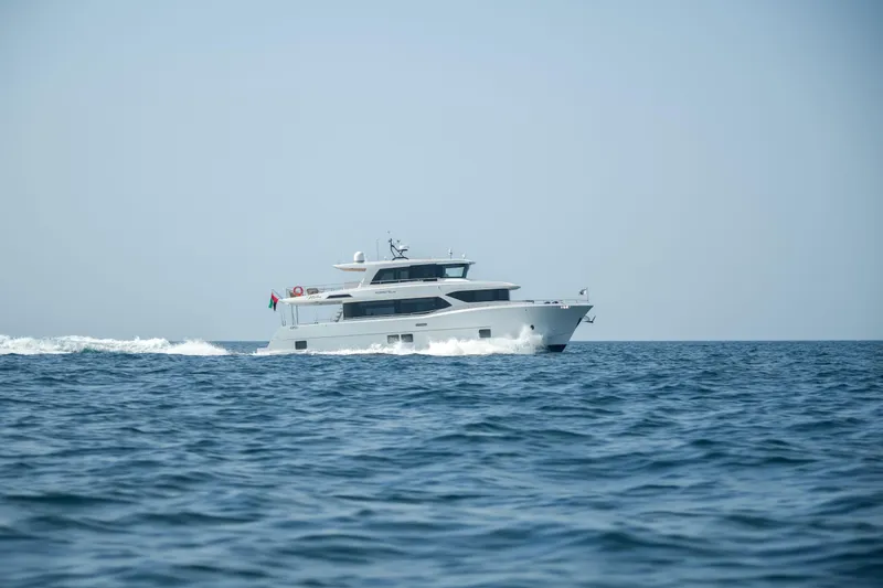 Slide: The Image of 2025 Nomad 70 SUV yacht cruising on open sea under clear sky. - 27