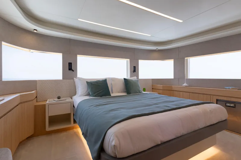 Slide: The Image of Luxurious bedroom interior of 2025 Nomad 70 SUV yacht with modern design and large windows. - 11