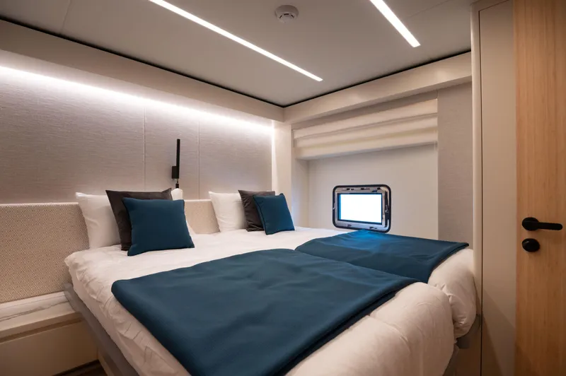 Slide: The Image of Luxurious bedroom interior in 2025 Nomad 70 SUV yacht, featuring modern design and ambient lighting. - 13