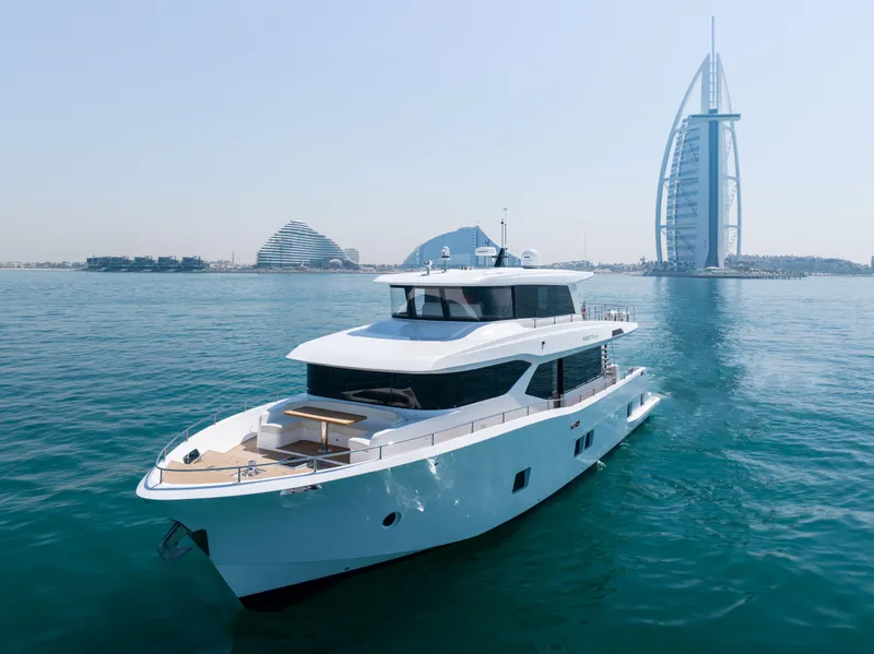 Slide: The Image of Luxurious 2025 Nomad 70 SUV yacht cruising near iconic Dubai skyline. - 22