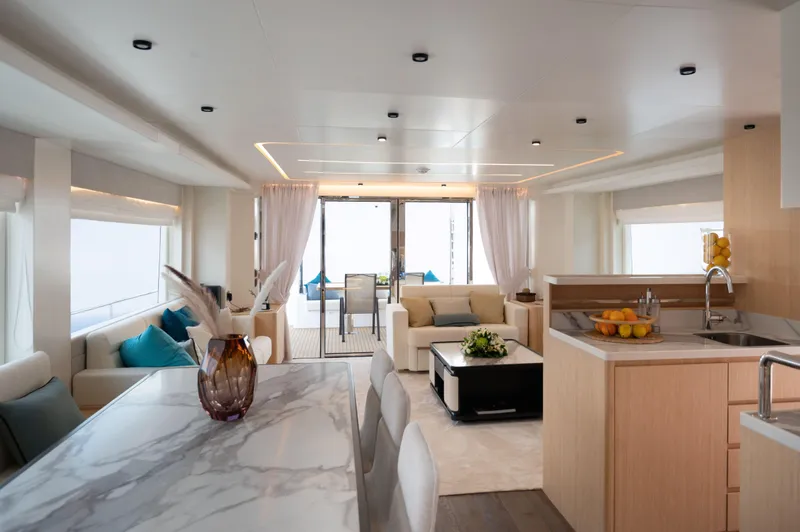 Slide: The Image of Luxurious interior of 2025 Nomad 70 SUV yacht with modern kitchen and elegant seating area. - 4