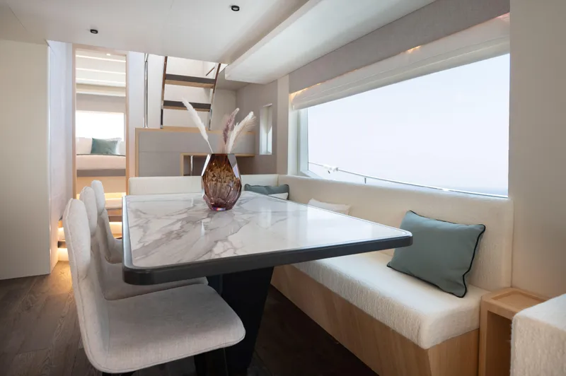 Slide: The Image of Luxurious interior of 2025 Nomad 70 SUV yacht with elegant dining area and modern decor. - 9
