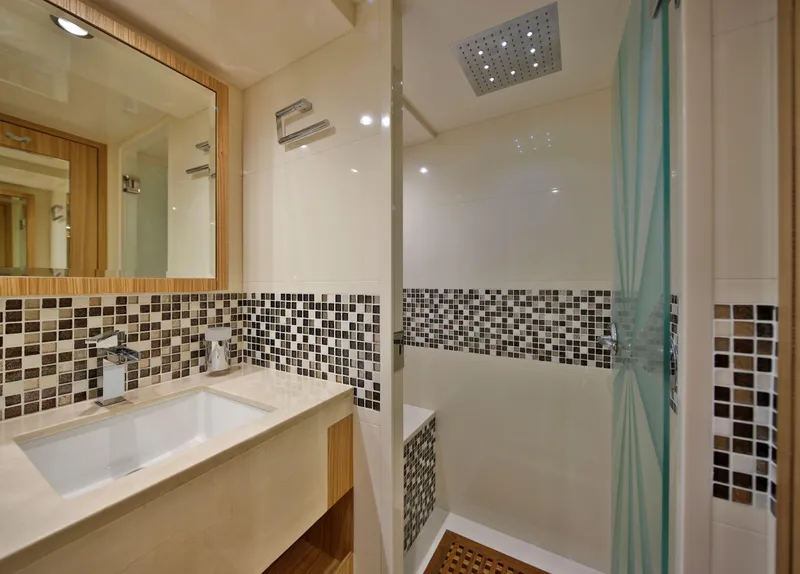 Slide: The Image of Modern bathroom in Nomad 65 yacht, 2025 model, featuring mosaic tiles and sleek fixtures. - 11