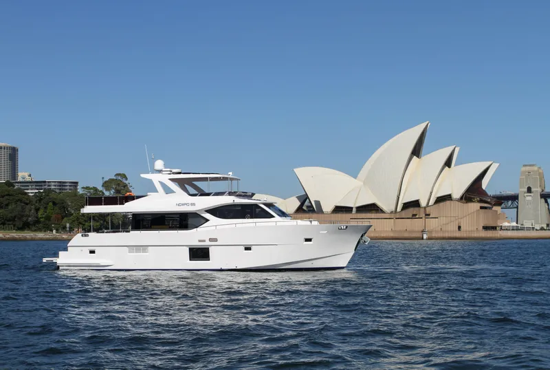 Slide: The Image of Luxury Nomad 65 yacht cruising near Sydney Opera House, 2025. - 13