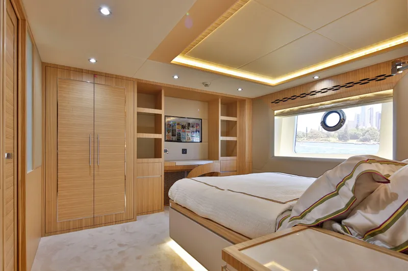Slide: The Image of Luxurious bedroom interior on 2025 Nomad 65 yacht, featuring modern design and elegant wood finishes. - 6